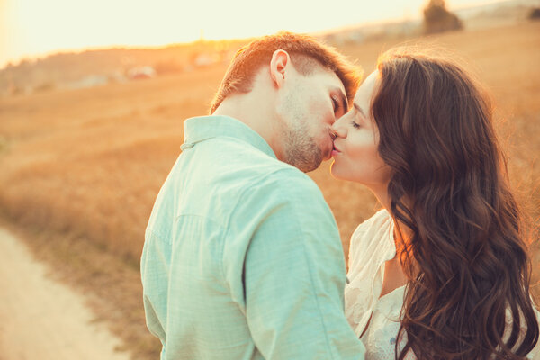 Young couple in love outdoor.Stunning sensual outdoor portrait of young stylish fashion couple posing in summer in  field