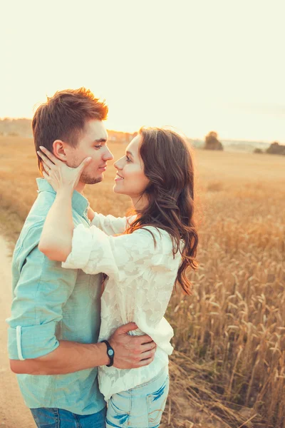 Молодая пара влюблена на открытом воздухе. Потрясающий чувственный открытый портрет молодой стильной моды пара позирует летом в поле — стоковое фото