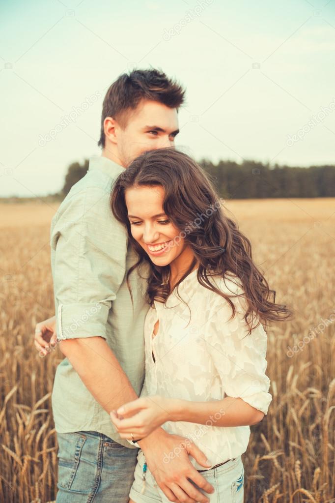 Laughing Young Couple Posing On Bed