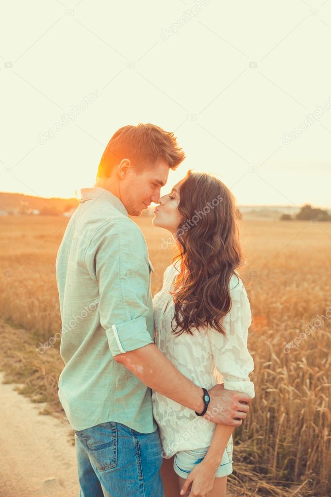 happy young couple posing high on country outdoor over yellow field,  romantic people concept, summer season Stock Photo | Adobe Stock