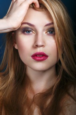 Beautiful woman face. Perfect color makeup. Beauty fashion. Eyelashes. Lips. Cosmetic Eyeshadow