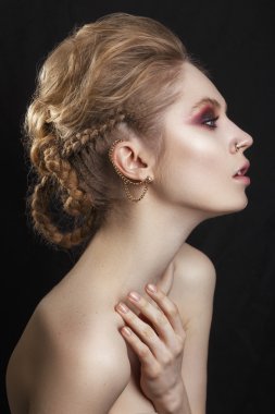 Portrait of a beautiful brunette girl with a mohawk, rock style.Fashion Rocker Style Model Girl Portrait. Hairstyle. Rocker or Punk Woman Makeup, Hairdo and Accessories