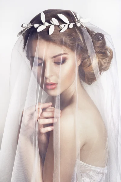 Bela noiva com penteado de casamento de moda - em fundo branco.Retrato de close-up de noiva linda jovem. Casamento. Estúdio shot.Beautiful retrato da noiva com véu sobre o rosto — Fotografia de Stock