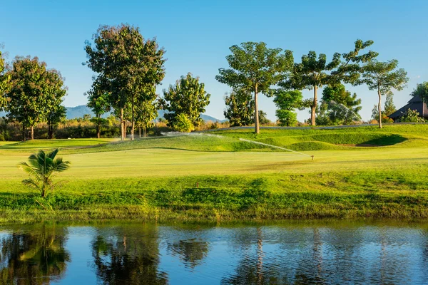 Watering in golf course — Stock Photo, Image