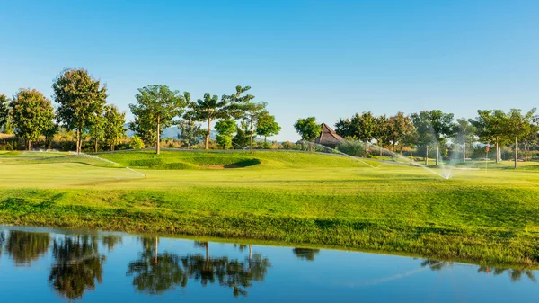 Watering in golf course — Stock Photo, Image