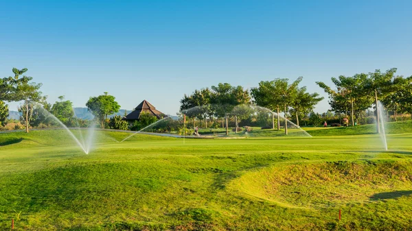 Watering in golf course — Stock Photo, Image