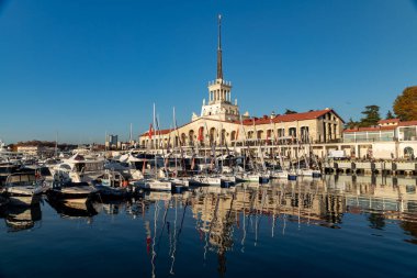 Güneşli bir günde Soçi 'de deniz istasyonunun inşaatı. Yat manzaralı..