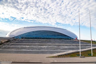 Adler, Sochi/Russia-October 2020: The Bolshoy Ice Palace in the Sochi Olympic Park on a sunny day with a view of the grand staircase and a sky with beautiful clouds.