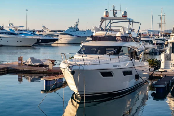 Gün batımında Sochi deniz istasyonunun yanındaki otoparkta kar beyazı bir yat. Etrafı başka gemilerle çevrili. Yakın plan..