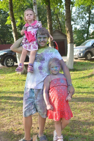 Children stained with paint at a music festival dedicated to the day of the city of Kuvshinovo. July 2018.