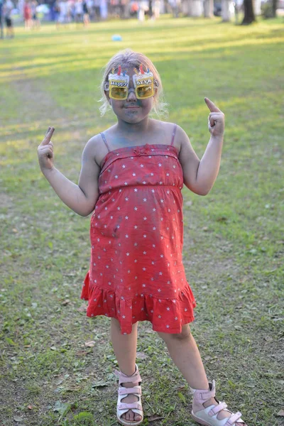 Children stained with paint at a music festival dedicated to the day of the city of Kuvshinovo. July 2018.