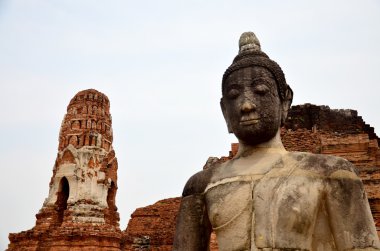 Kırık Buda heykeli ve eski bina