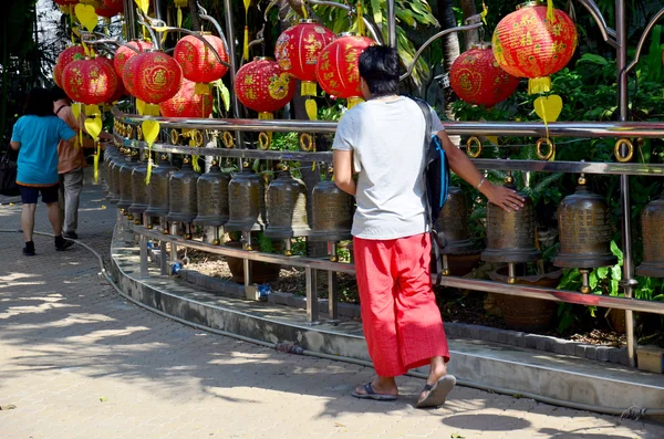 Thai man spinning Prayer Bell wheels — Stock Photo, Image