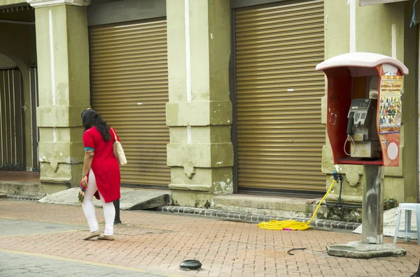 Malaysian woman people walking leave public telephone — Stock Photo, Image