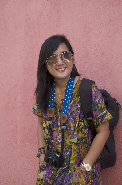 Traveller thai woman portrait with red wall background