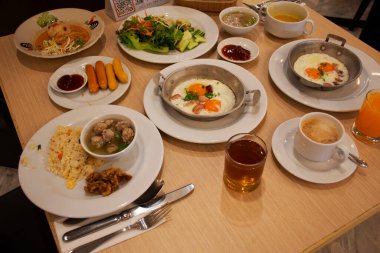 Tayland, Udon Thani 'de sabah saatlerinde Udonthani' deki yerel bir restoranın yemek salonunda yemek yiyen gezginler için yemek masasında Tayland usulü Tayland yemeği.