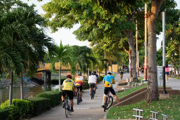 2020年9月15日 タイのウドタニーにあるNong Prajak公園で 夕暮れ時にアジア系タイ人と外国人旅行者が歩道を自転車でジョギングしています — ストック写真