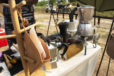 Tools equipment and material for thai men barista people use drip coffee maker or dripper made hot and iced coffee and tea for sale at outdoor of cafe shop at Bangbuathong city in Nonthaburi, Thailand