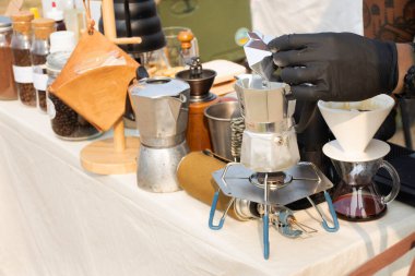 Tools equipment and material for thai men barista people use drip coffee maker or dripper made hot and iced coffee and tea for sale at outdoor of cafe shop at Bangbuathong city in Nonthaburi, Thailand