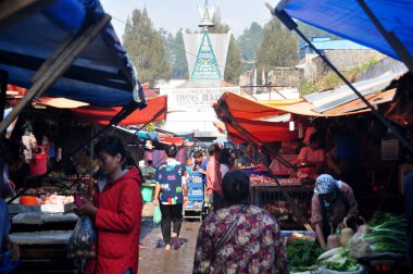 Indonesian people and foreign travelers walking buy sell food product and travel visit local bazaar market in Kabupaten Karo Berastagi at Sumatera Utara on March 31, 2016 in North Sumatra, Indonesia