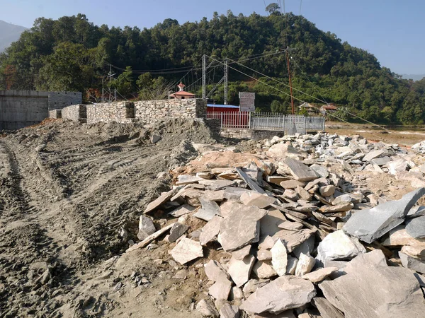 Construction site for napali people work build stone concrete irrigation reservoir dam and repair maintenance phewa road in countryside rural hill valley village of Gandaki Pradesh in Pokhara, Nepal