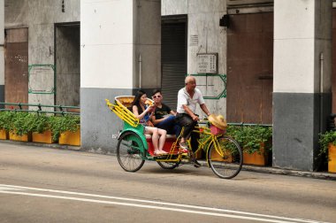19 Nisan 2015 'te Çin' in Macau kentinde Macao Özel İdari Bölgesi 'nde Macao halkı ve yabancı yolcular için klasik antika trishaw bisiklet turu
