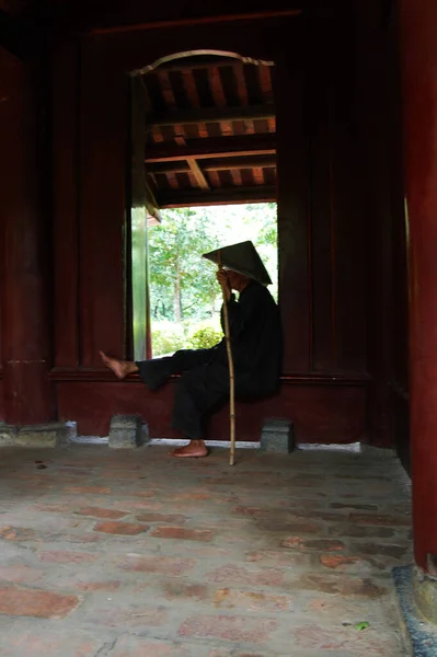 Vietnamese old women people sit alone for waiting family receive go home in King Emperor Dinh Tien Hoang Temple and Nhat Tru Pagoda of Hoa Lu ancient capital at Ninh Binh city in Hanoi, Vietnam