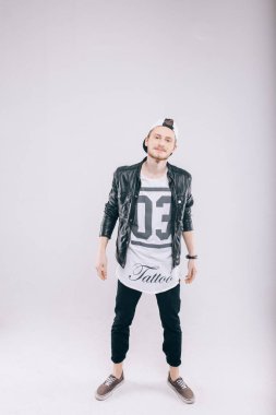 Stüdyoda beyaz arka planda yakışıklı bir genç var.