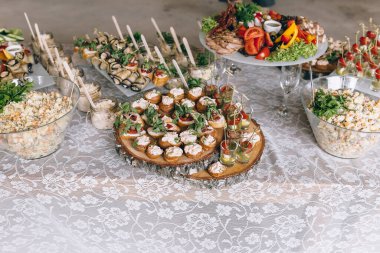 İtalyan antipasti şarap aperatifleri. Fırçalar, peynir çeşitleri, Akdeniz zeytinleri, turşular, kavunlu Prosciutto di Parma, salam ve şarap siyah grunge arka planda, üst manzara