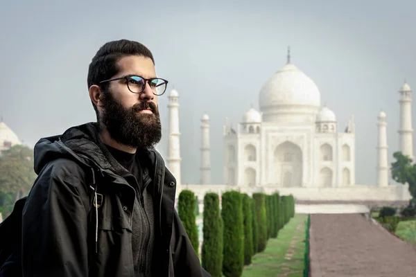 Young man in solo travel lifestyle having holiday in Taj Mahal, India