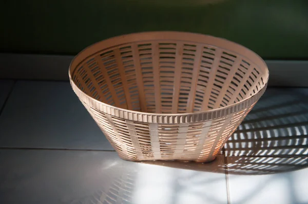 The sunlight reflected the empty basket on the ground