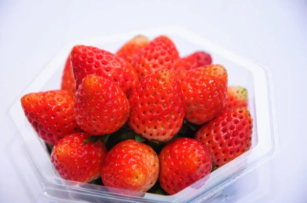 Fresh strawberries in a transparent box