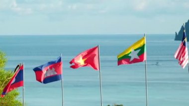 ASEAN topluluğunun bayrağını dalgalandıran Laos, Kamboçya, Malezya, Vietnam ve Myanmar 'ın birleşmesi deniz arka planında, dağlarda ve mavi gökyüzünde özgürce dalgalanan. Ve adanın güzel manzarası.