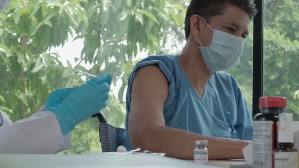 Γυναίκα Γιατρός Μάσκα Προσώπου Που Εμβολιάζει Τον Άνδρα Ασθενή Προστατεύει — Αρχείο Βίντεο