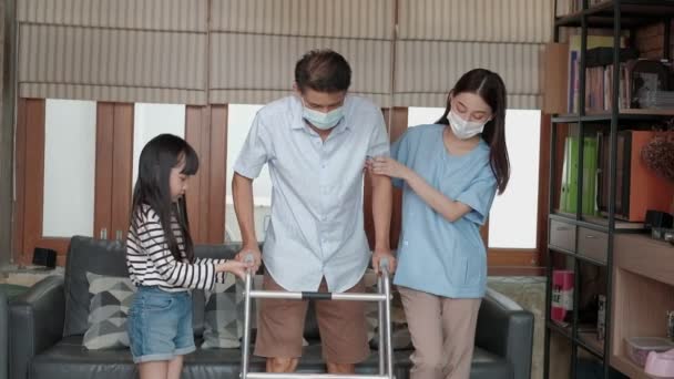 亚洲女性理疗师在私人家中帮助 训练和康复一名老年残疾男子 保健指导 身体康复 有孙女在旁边支持 — 图库视频影像