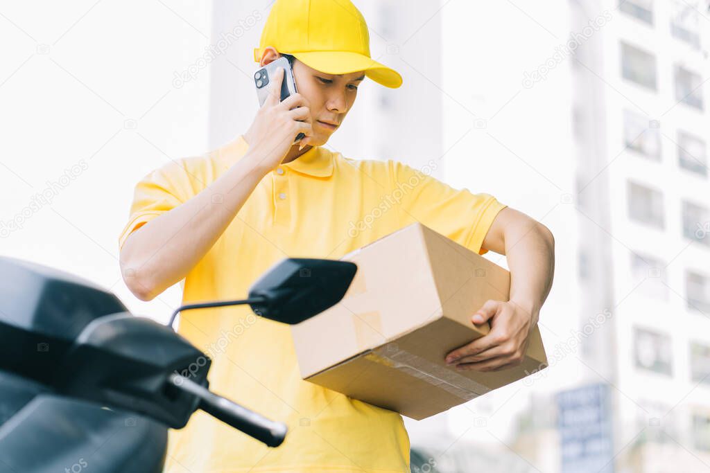Asian shipper is calling the customer to get the goods