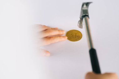 Asian woman using hammer to break her coin