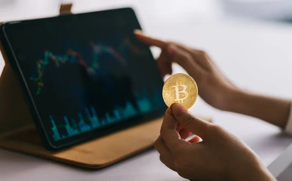 Asian Woman Holding Coin Hand While Watching Stock Chart — Stock Fotó