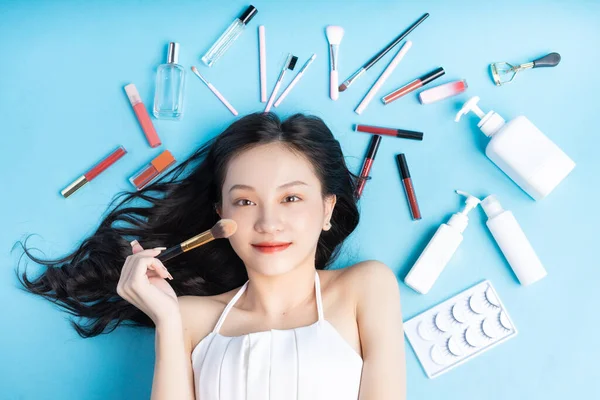 Mulher Asiática Deitada Fundo Azul Com Maquiagem Redor — Fotografia de Stock