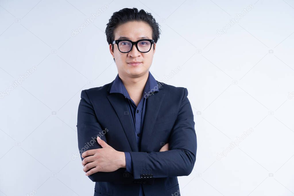 Portrait of Asian businessman standing with arms crossed
