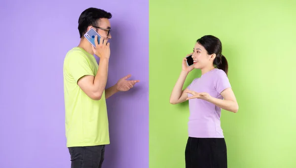 Young Asian couple using smartphone, long distance love concept