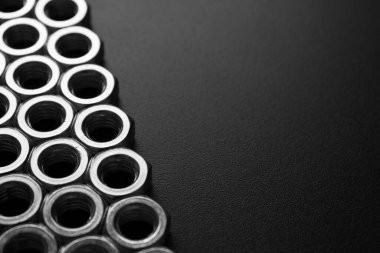 screw-nuts on a dark surface