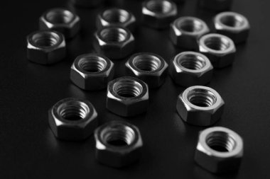 screw-nuts on a dark surface