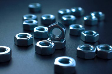 screw-nuts on a dark surface