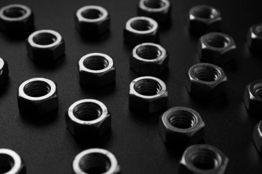 screw-nuts on a dark surface