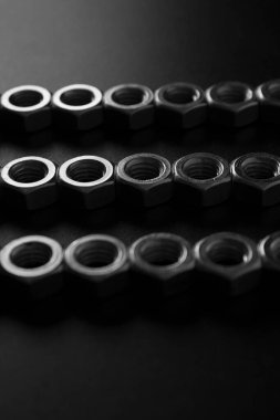 screw-nuts on a dark surface