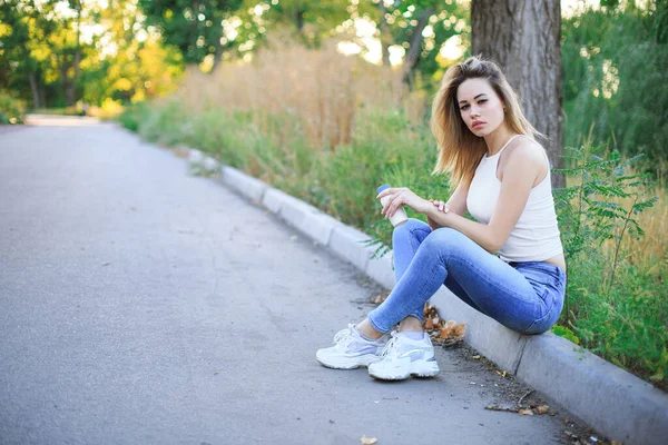 Young Woman Sitting Curb Alley Park Holding White Bottle Her — Stock Photo, Image