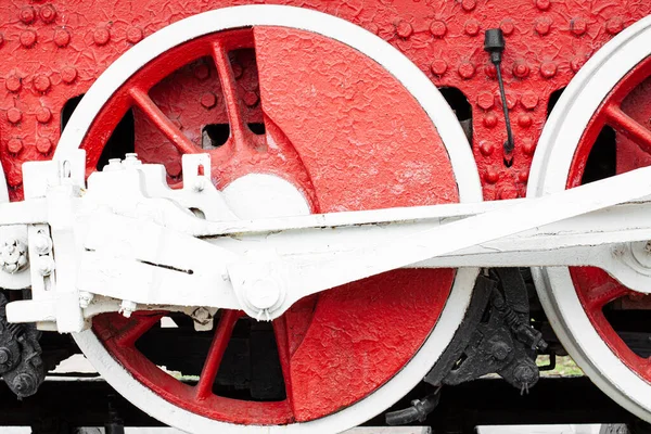 Red wheels of a rare museum steam locomotive on rails