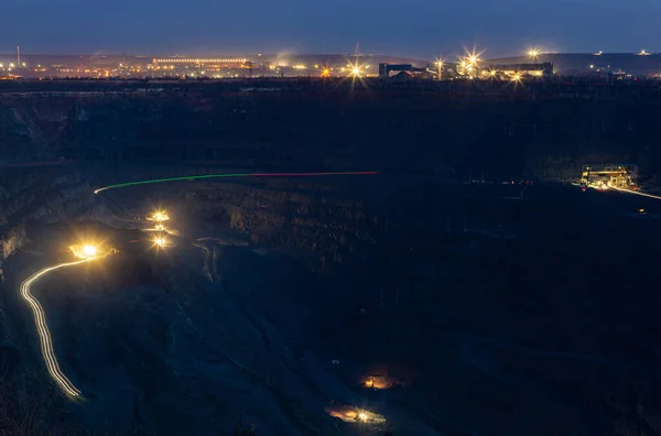 The process of iron ore mining in the quarry at night. Round-the-clock production process