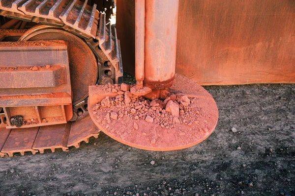 Suportes Hidráulicos Para Guindaste Sobre Esteiras Manchado Com Pedras Vermelhas — Fotografia de Stock